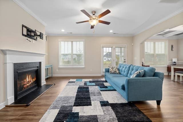 ceiling fan over living room furniture to cool people down 
